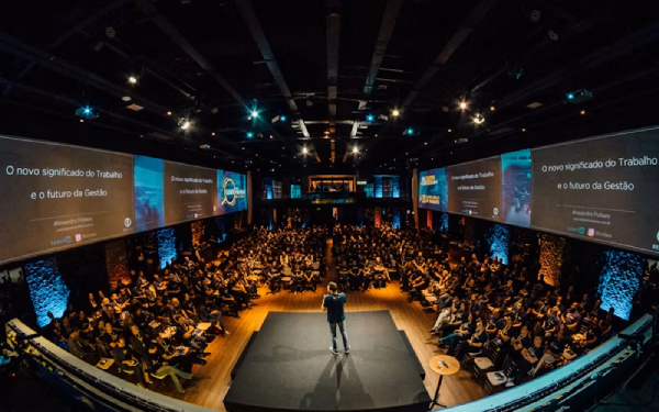 Speaker presenting at a live conference